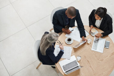 high-angle-shot-of-a-group-of-businesspeople-having-a-meeting-in-a-modern-office