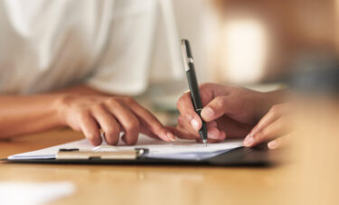 shot-of-a-businesswoman-signing-a-contract-at-work